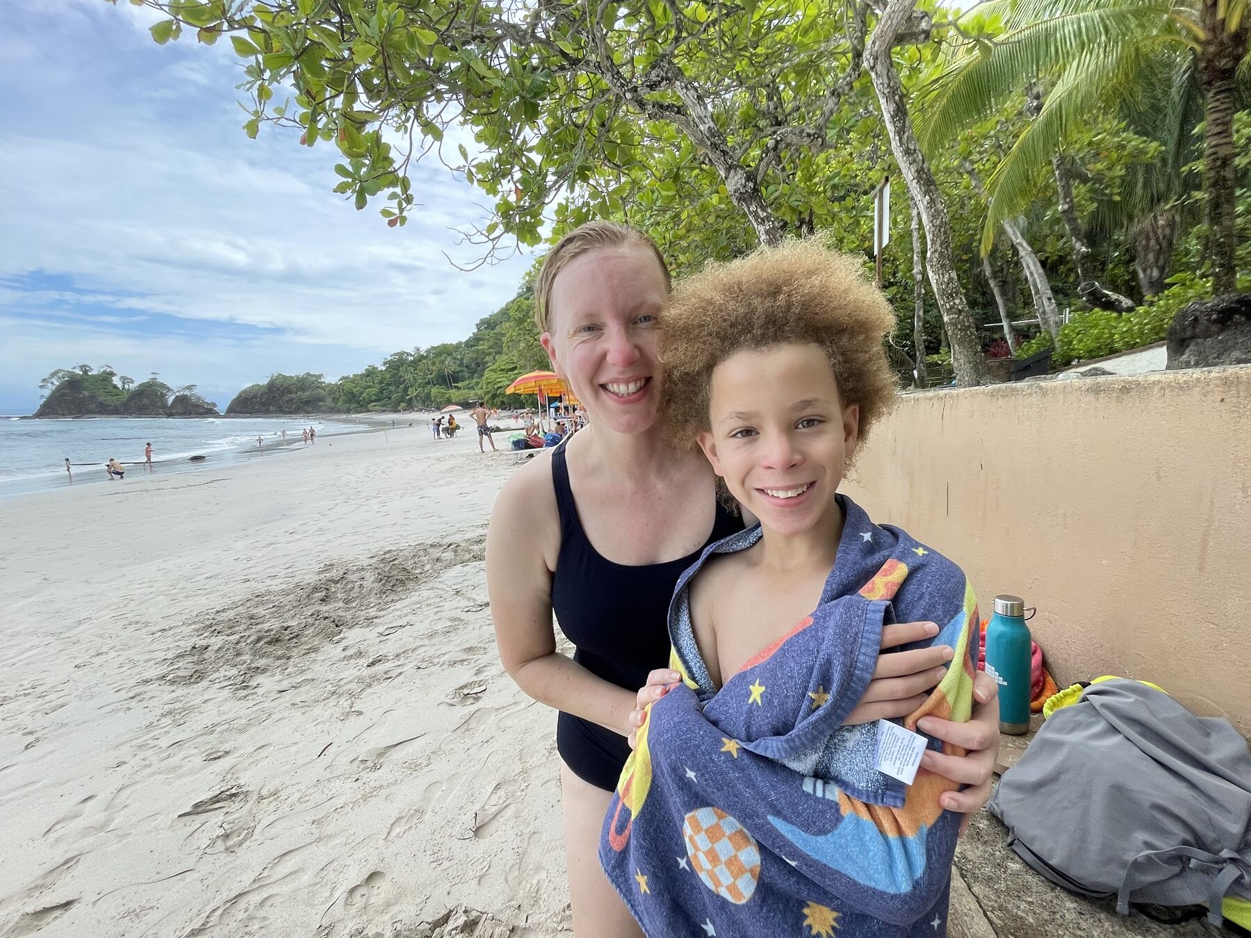 Britta and Ethan on the white sand beach after their Snorkel Jaco tour