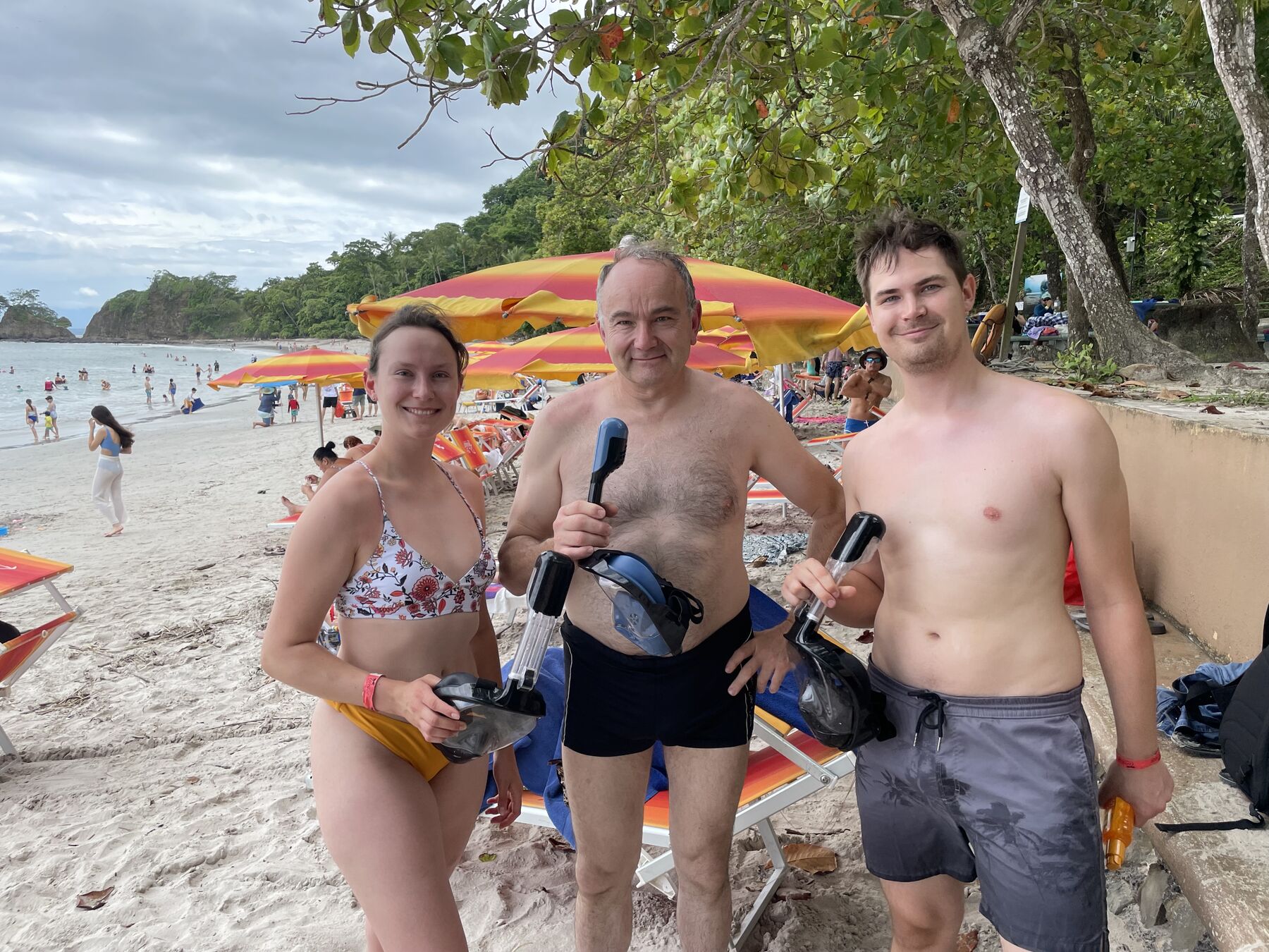 Guests with their snorkel gear by the beach umbrellas at Playa Mantas — Jaco Costa Rica best snorkeling