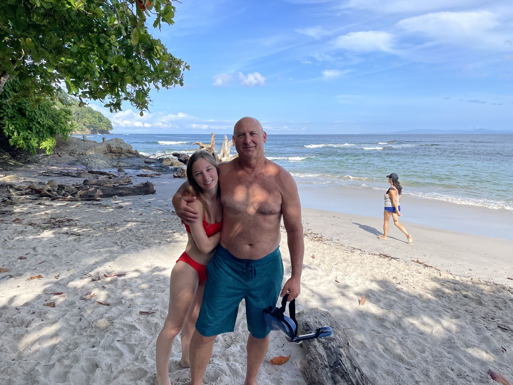 A happy couple on the sand at Playa Mantas — top snorkel tour Jaco beach