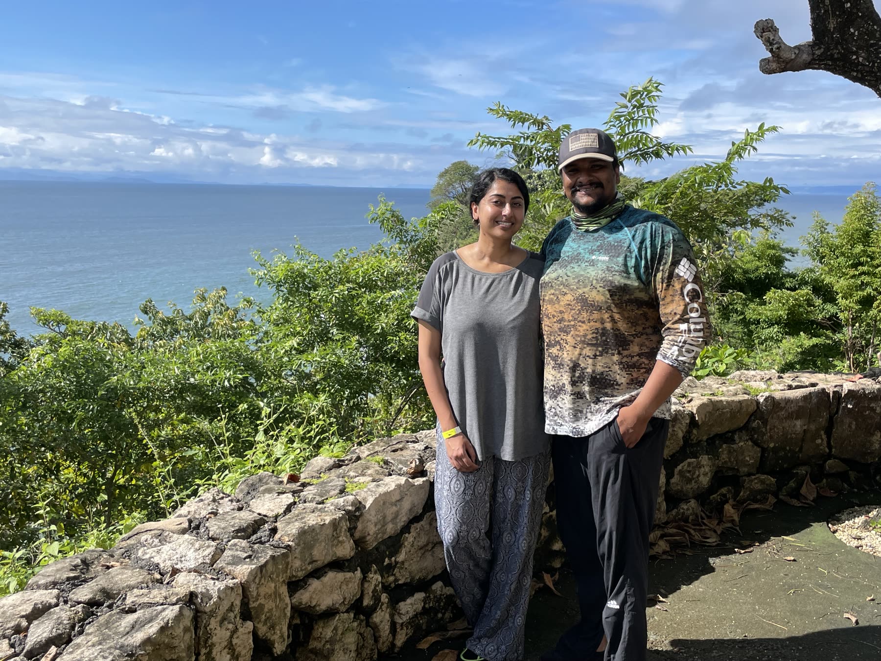 A couple at the cove wall at Playa Mantas on a best snorkel tour Jaco beach day