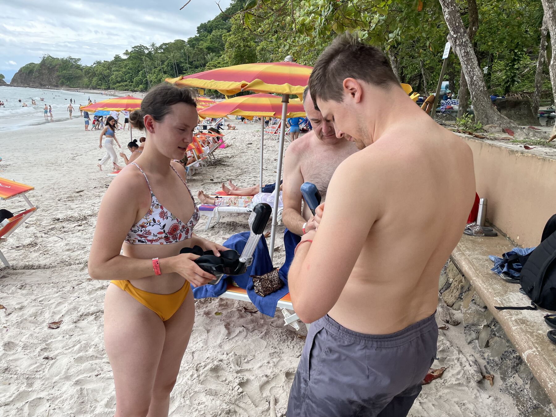 Guests sorting their gear by the beach umbrellas at Playa Mantas — top snorkel tour Jaco beach