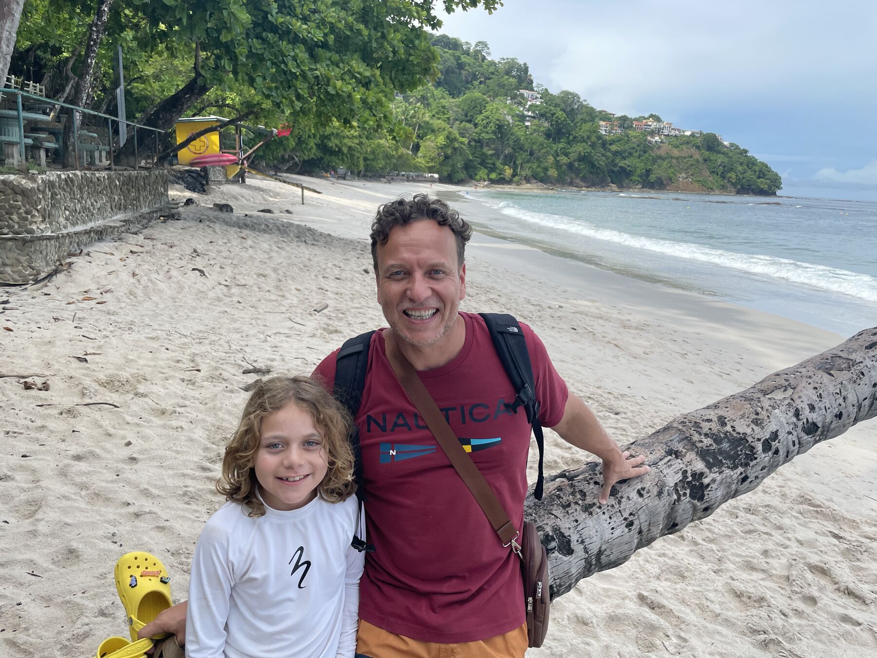 A dad and his son by the palms on the beach at Playa Mantas — top snorkel tour Jaco beach
