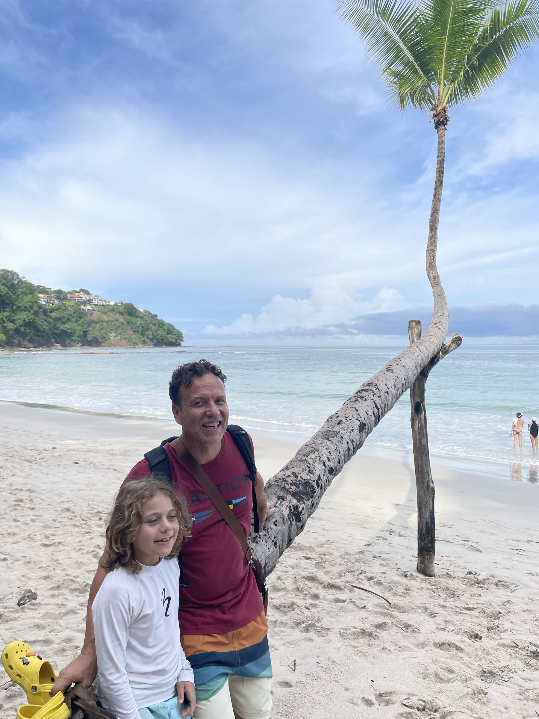 A dad and kid by the palms at Playa Mantas — top snorkel tour Jaco beach