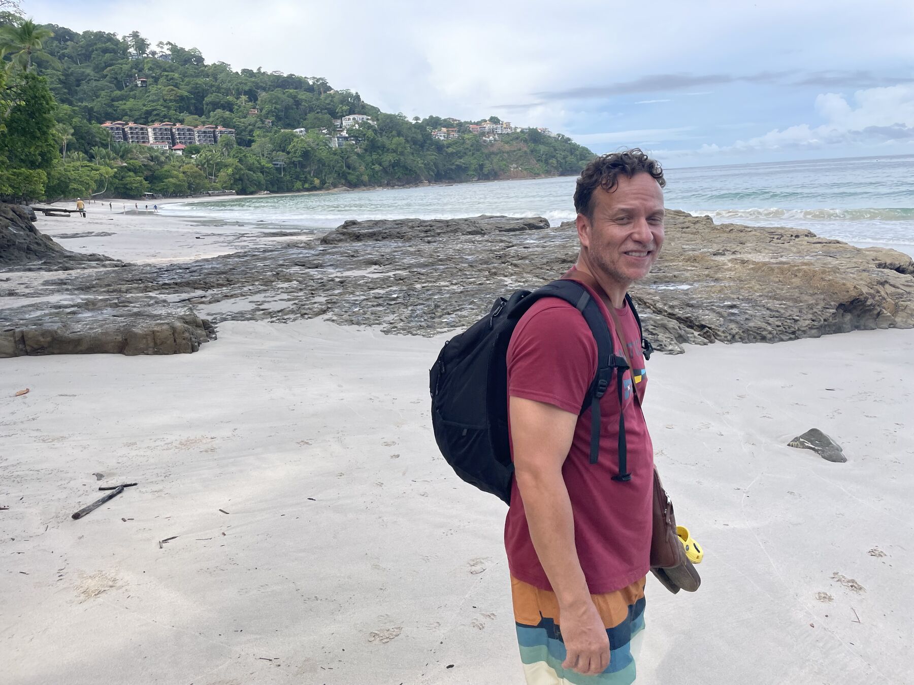 A guest on the sand with the cove behind at Playa Mantas — top snorkel tour Jaco beach