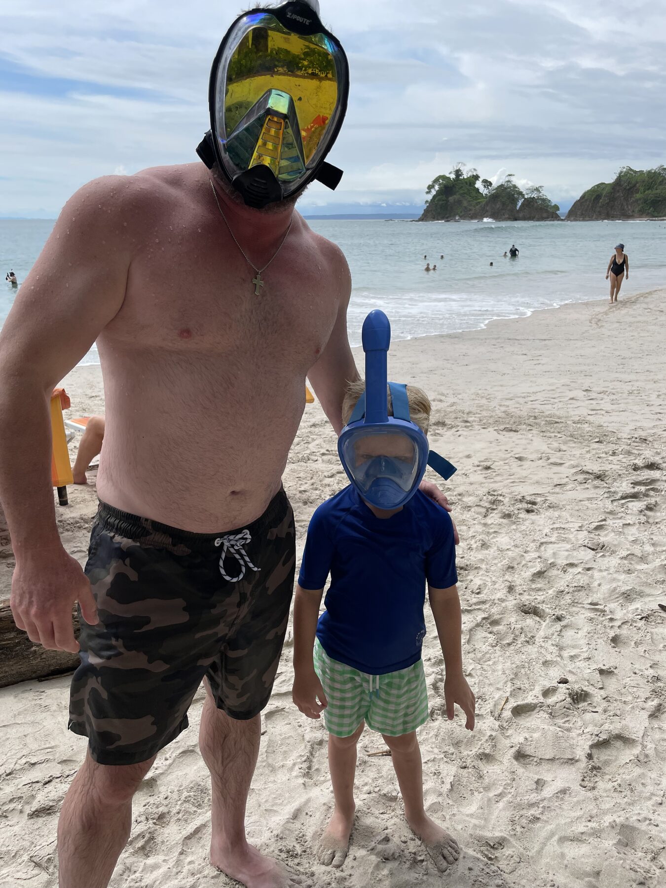 A dad and son in full-face snorkel masks at Playa Mantas on a best snorkel tour Jaco beach day