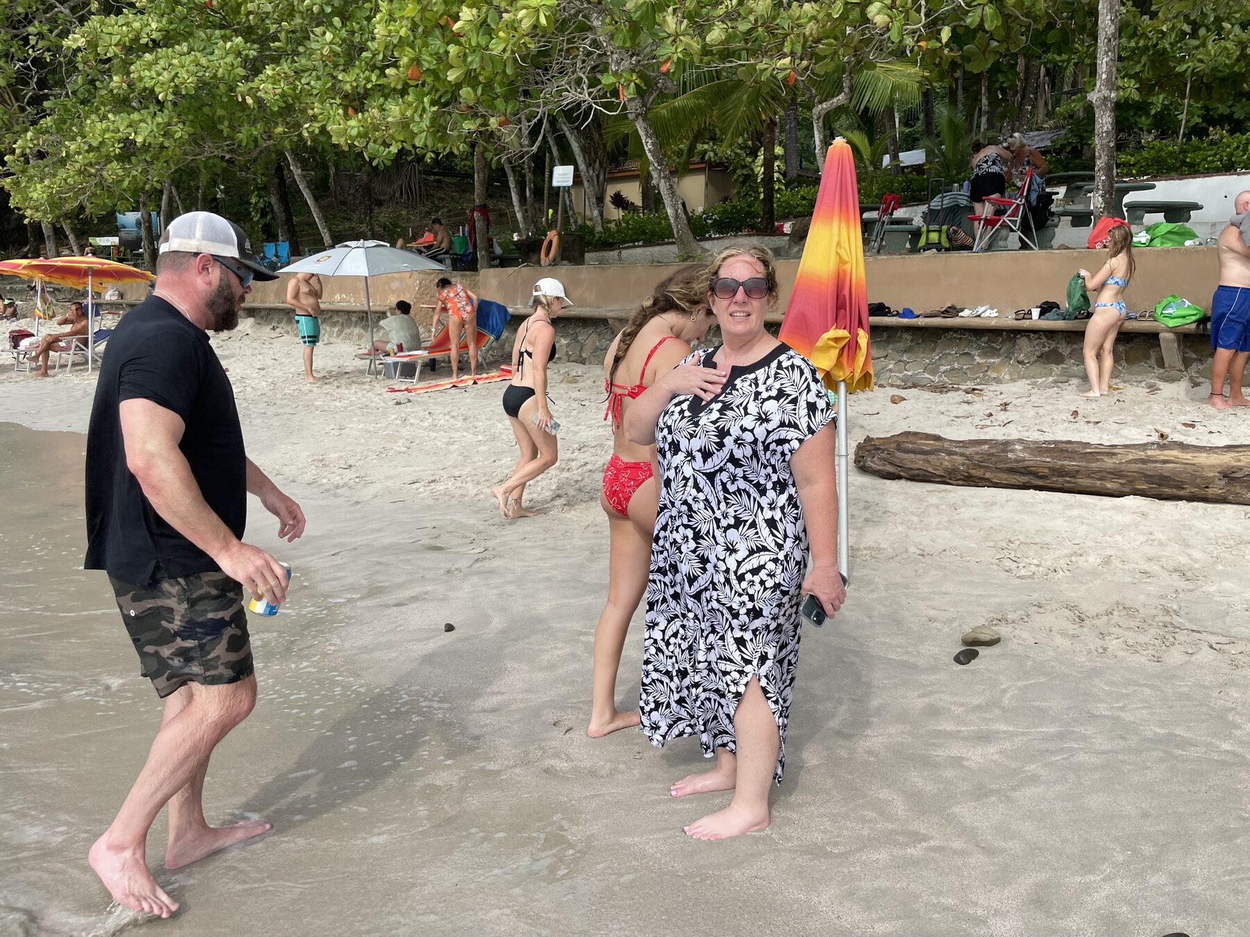 Guests spread out on the sand near the shallows at Playa Mantas — Jaco Costa Rica best snorkeling