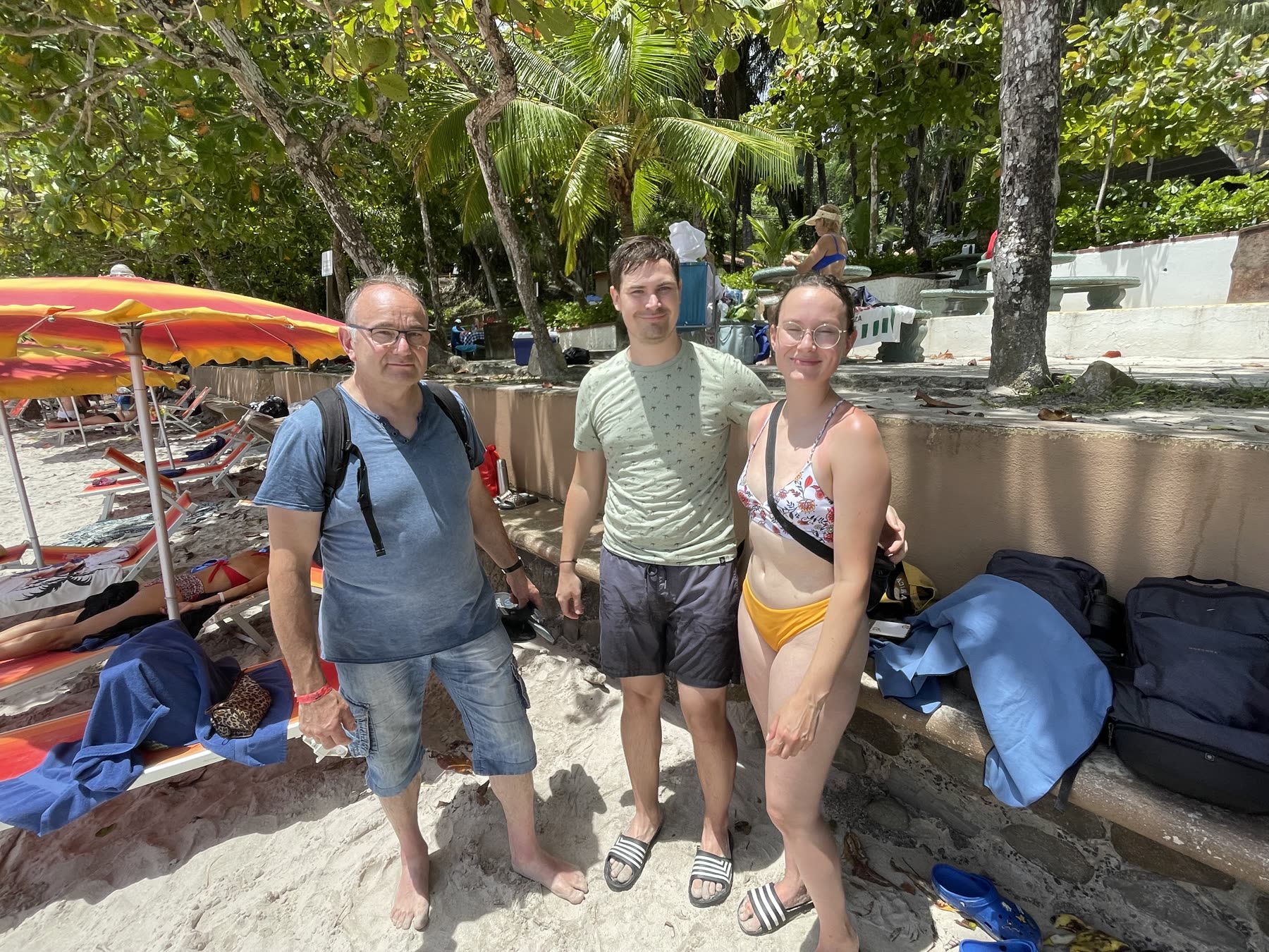 A family at the beach umbrellas at Playa Mantas on a best snorkel tour Jaco beach day