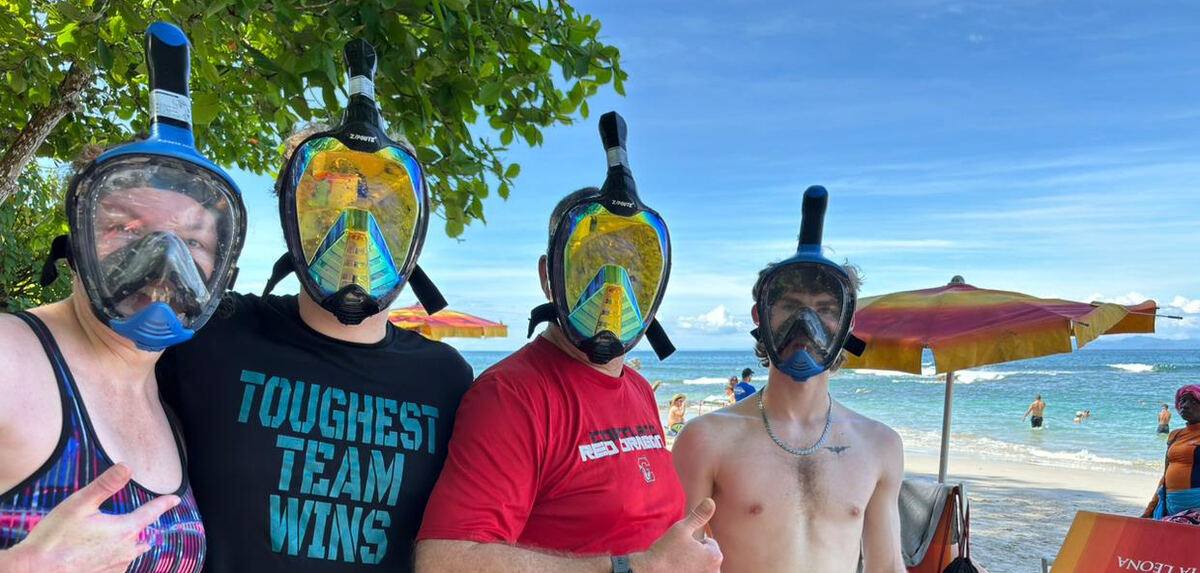 Tour group wearing snorkel masks ready to swim