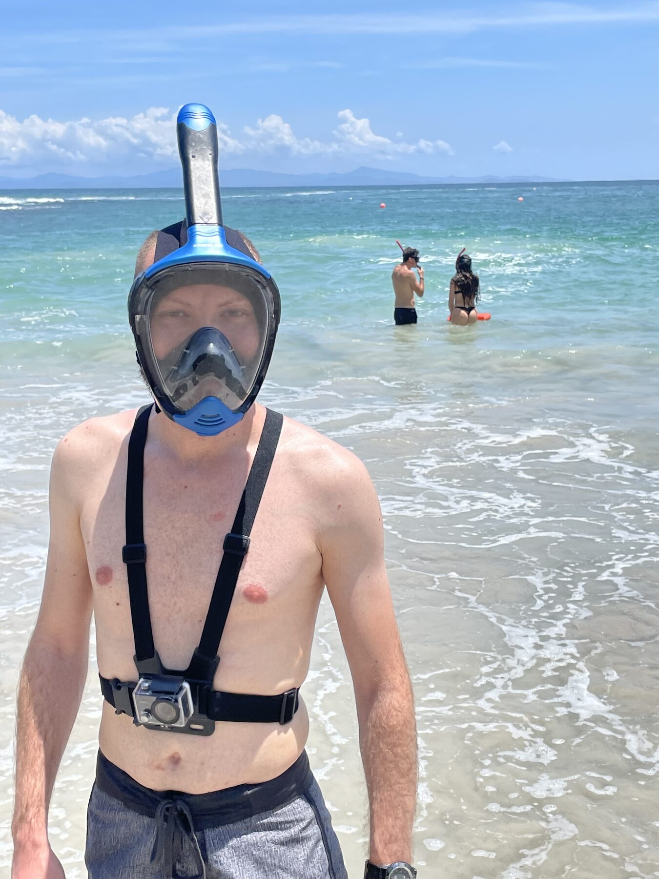 A guest in a full-face snorkel mask at the water's edge at Playa Mantas on a best snorkel tour Jaco beach day