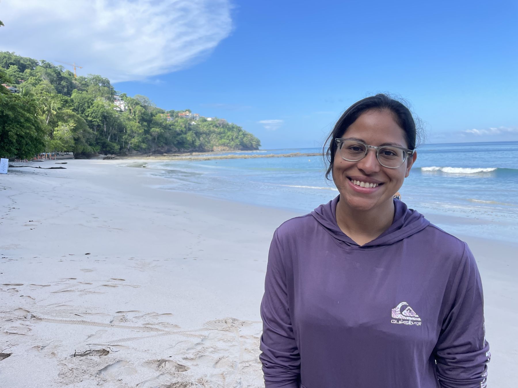 A happy Snorkel Jaco guest on the white sand beach at Playa Mantas