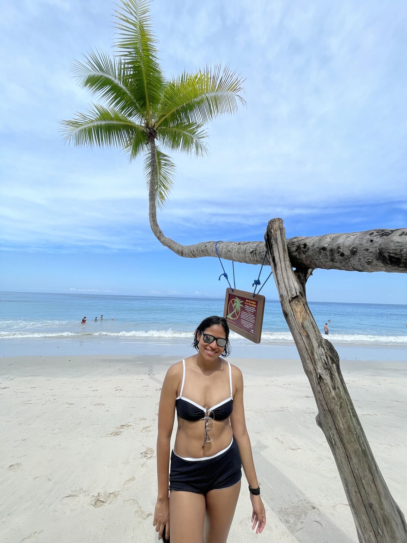A guest relaxing under a palm at Playa Mantas after a snorkel tour — Jacó beach snorkel tours