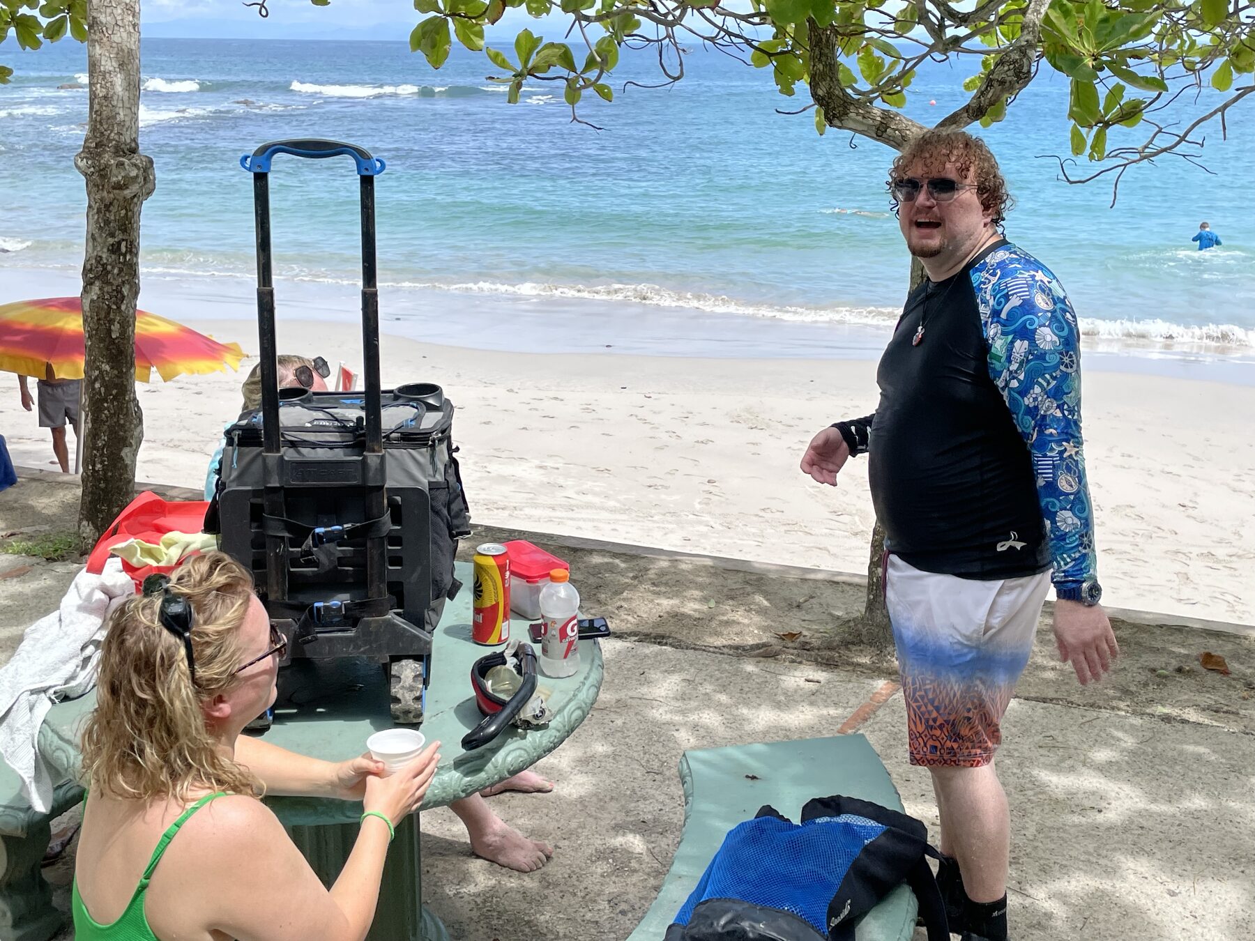 A guest by the cooler and picnic table at Playa Mantas — Jaco Costa Rica best snorkeling