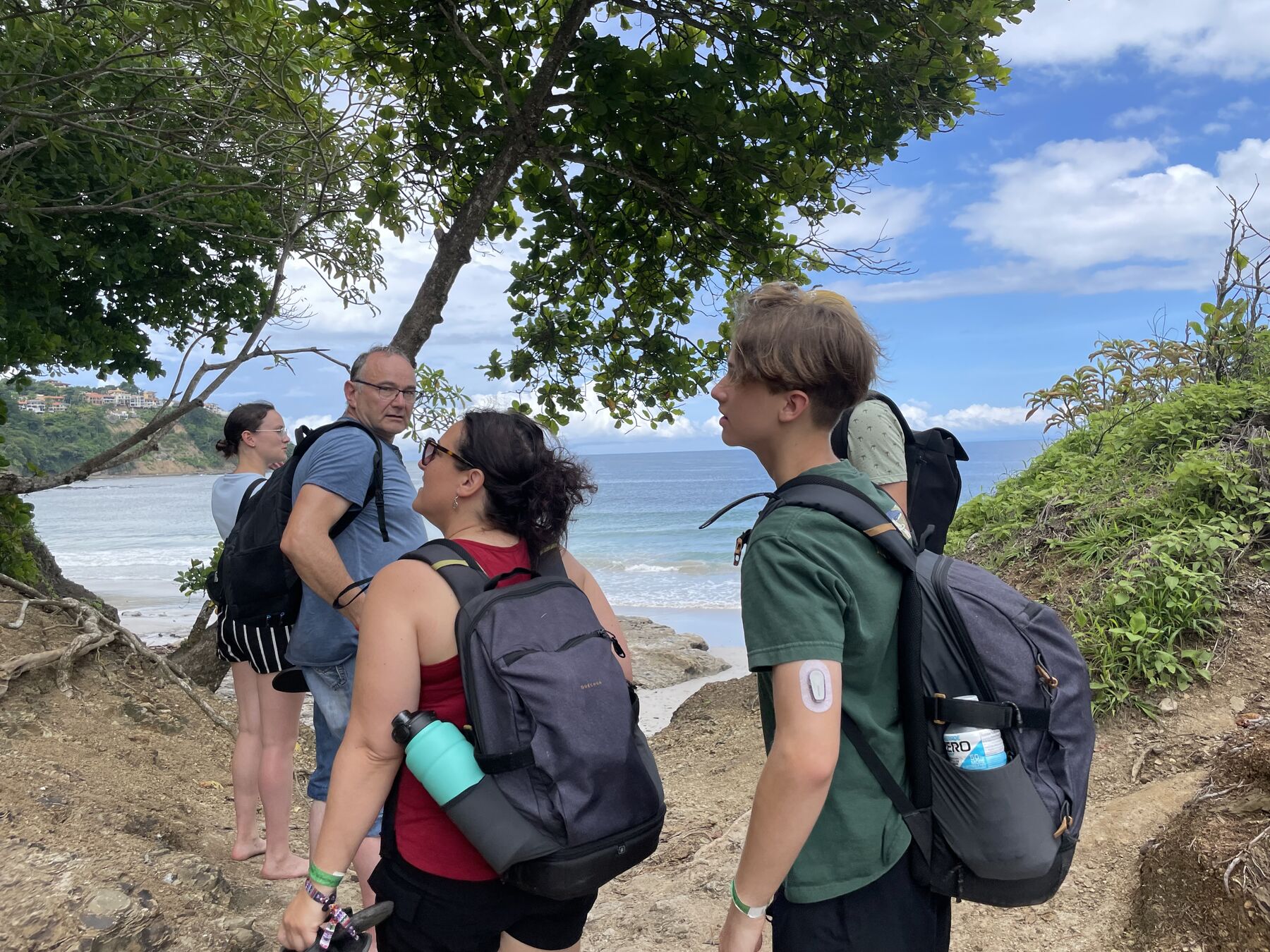 Guests on the trail with the cove view at Playa Mantas — top snorkel tour Jaco beach