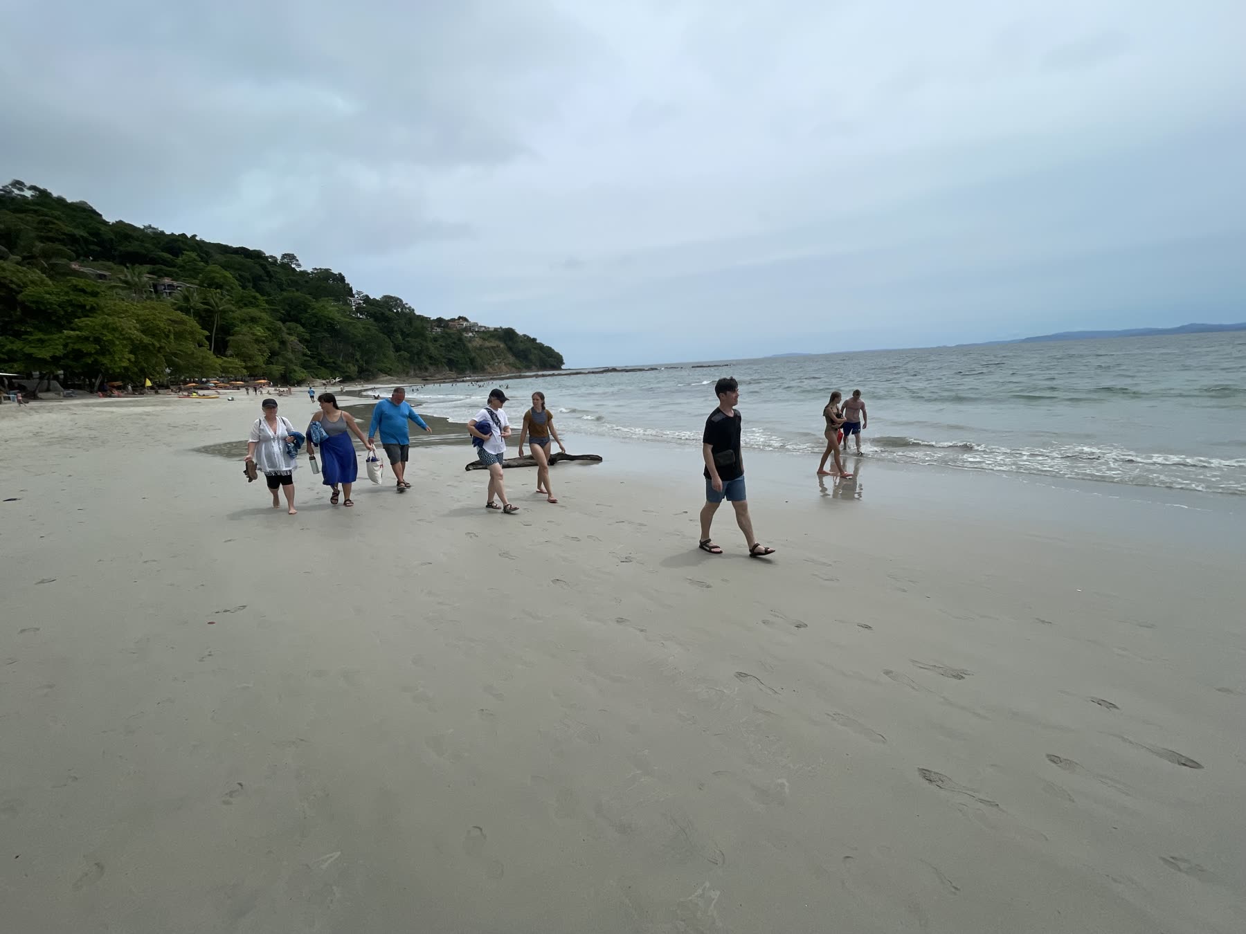 Guests walking the shore at Playa Mantas — top snorkel tour Jaco beach