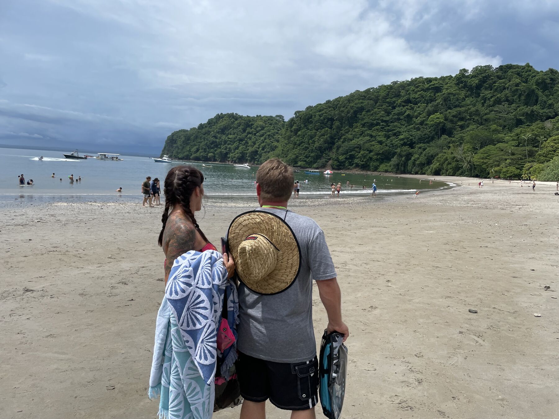 Guests walking the wide white-sand beach at Playa Mantas — Jaco Costa Rica best snorkeling