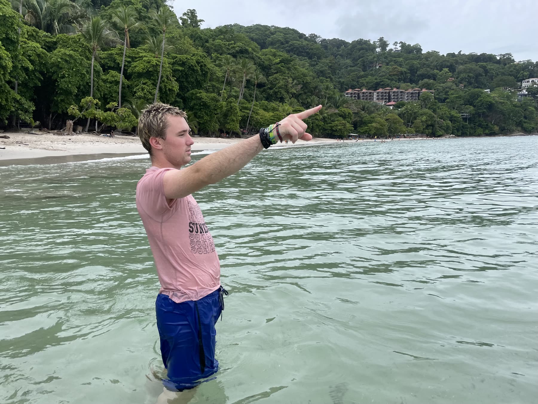 A guest pointing out something in the water at Playa Mantas — top snorkel tour Jaco beach