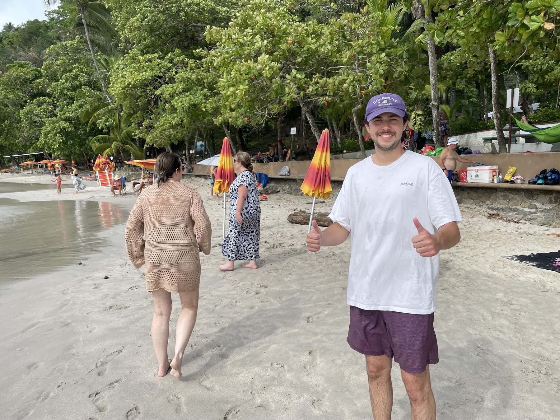 A guest giving a thumbs-up on the sand at Playa Mantas — Jaco Costa Rica best snorkeling
