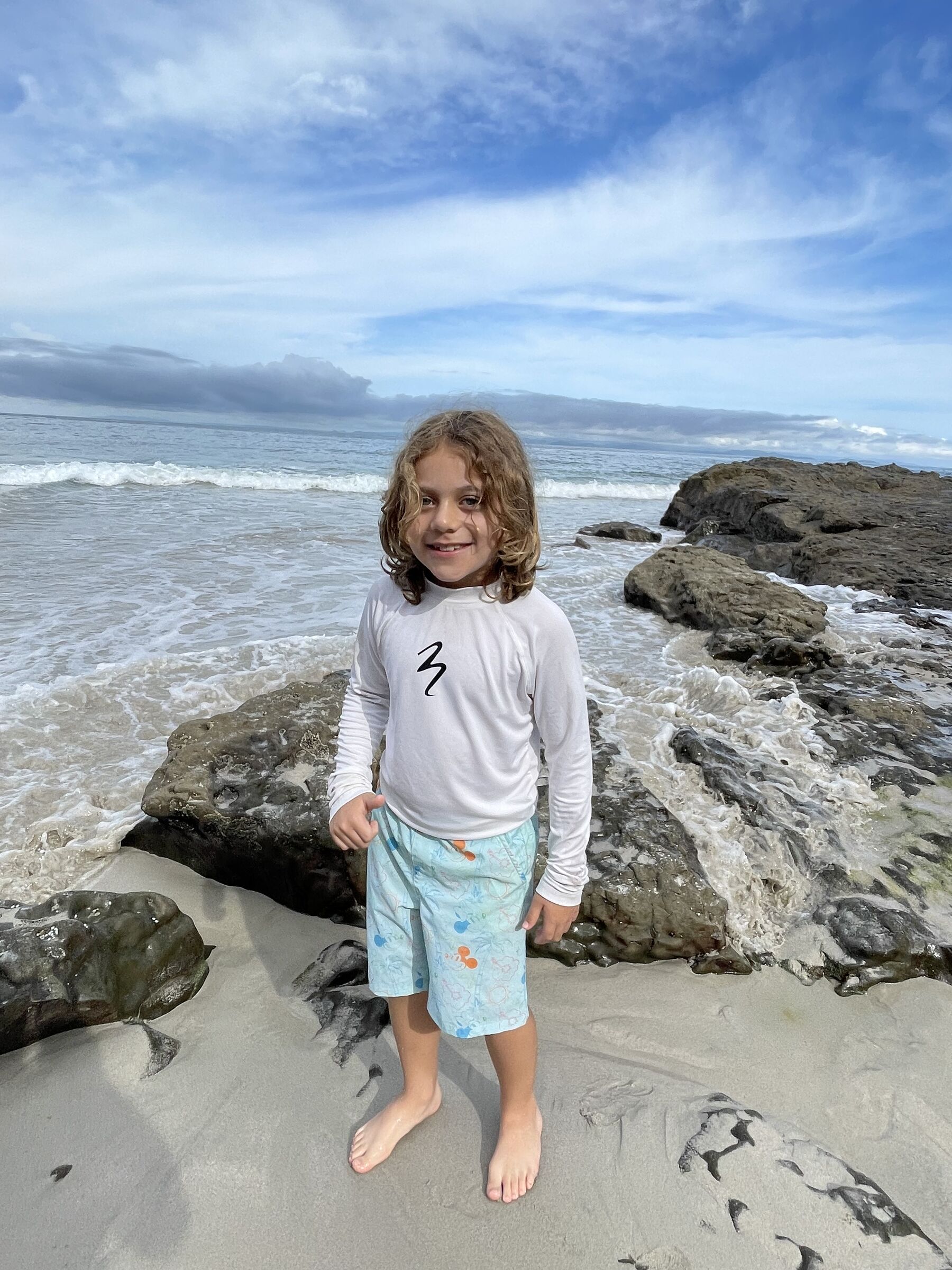 A young guest by the headland rocks at Playa Mantas — Jaco Costa Rica best snorkeling