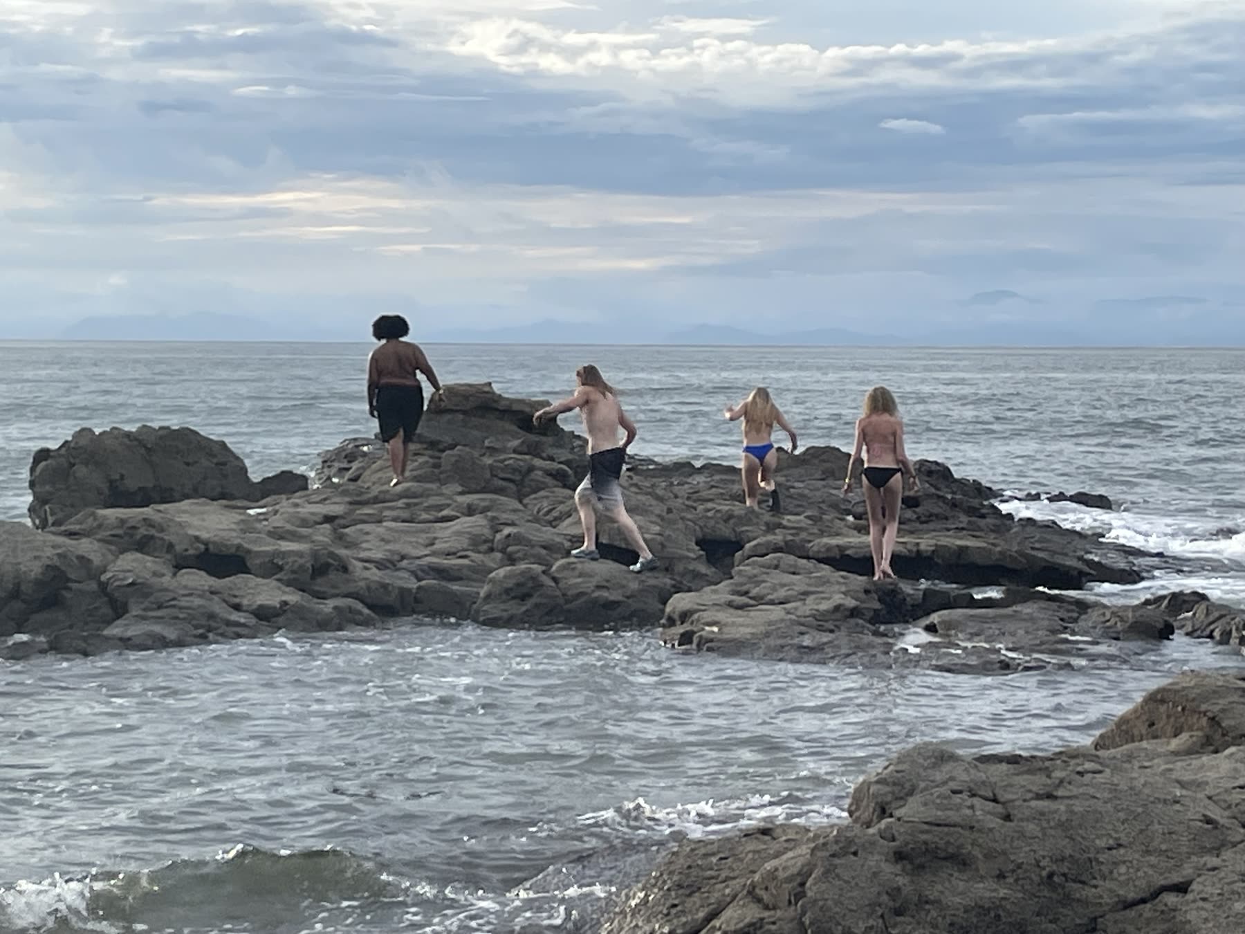 Kids climbing the rocks at Playa Mantas — Jaco Costa Rica best snorkeling