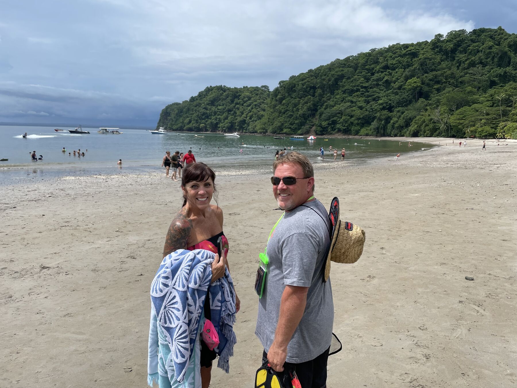 A dad and his son wrapped in towels on the beach at Playa Mantas — top snorkel tour Jaco beach