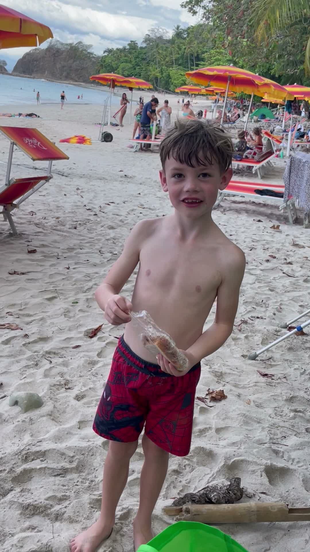 A young guest on the beach at Playa Mantas watching the monkeys on a best snorkel tour Jaco beach day