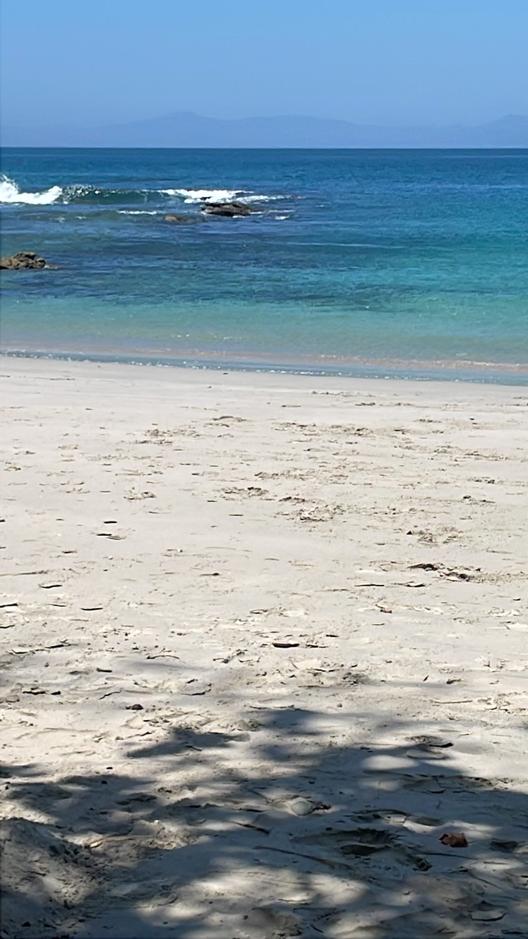 Shallow, clear snorkeling water at the Playa Mantas cove near Jacó, Costa Rica