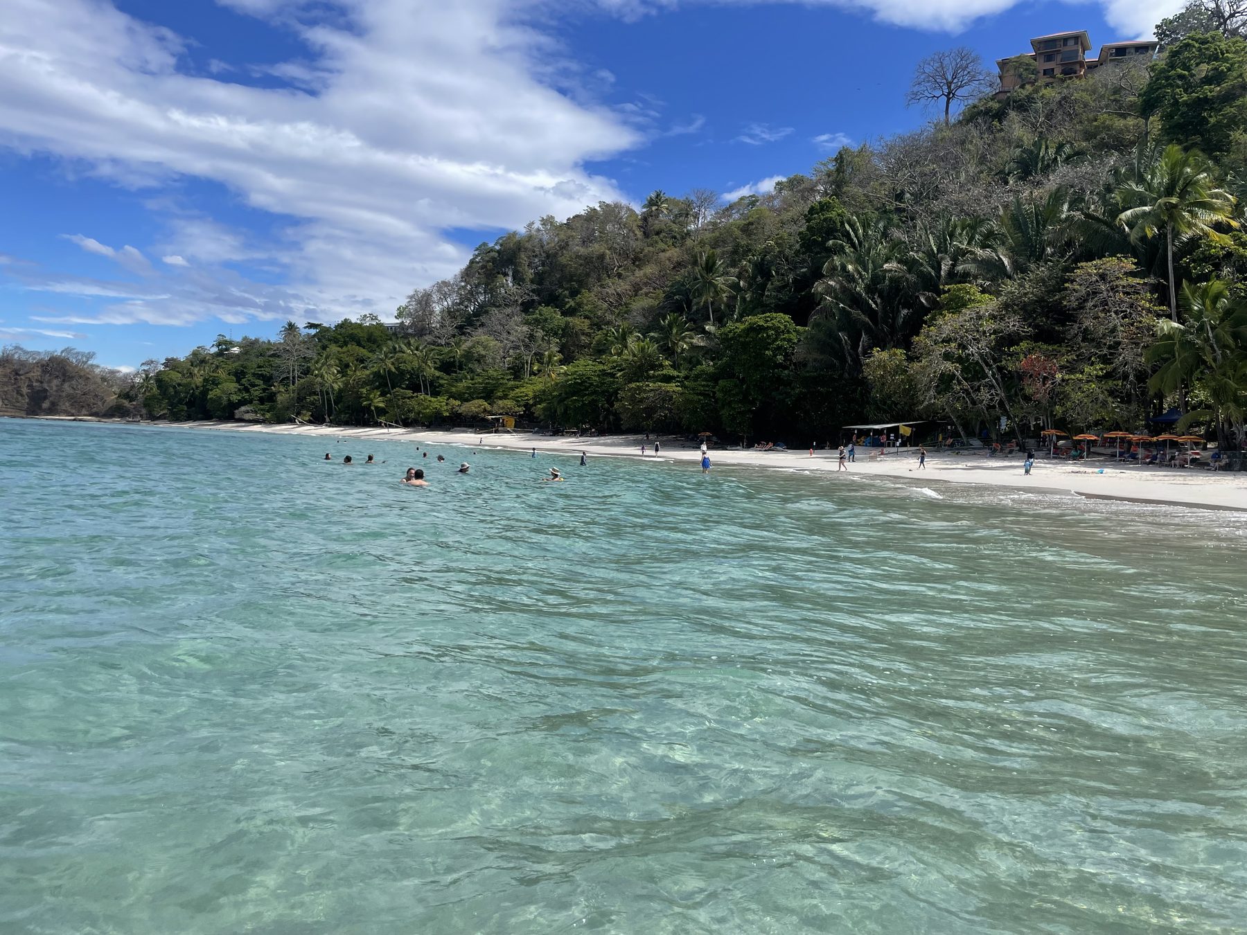 Morning light over the snorkeling cove and green headland near Jacó Beach, Costa Rica