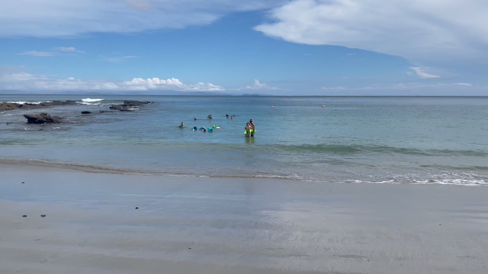 Guests snorkeling the reef in the clear shallows at Playa Mantas on a best snorkel tour Jaco beach day