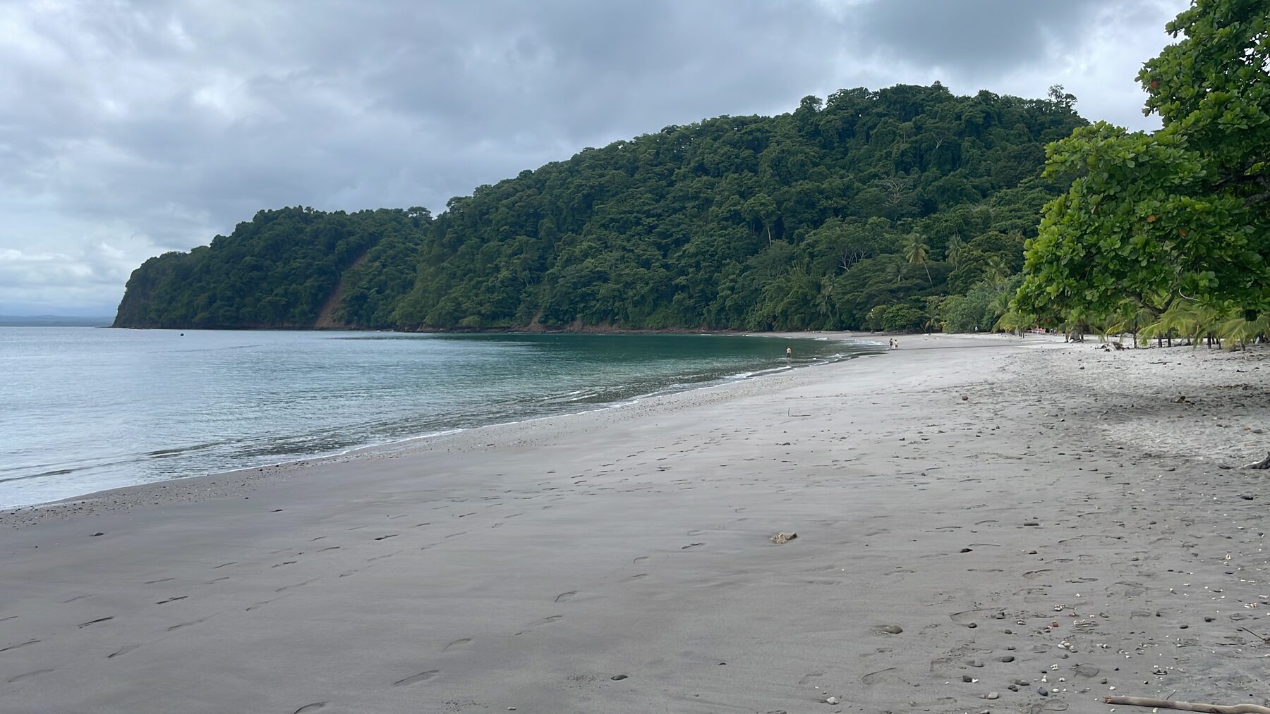 Calm, clear white-sand cove near Playa Mantas, the best snorkeling spot near Jacó Beach, Costa Rica