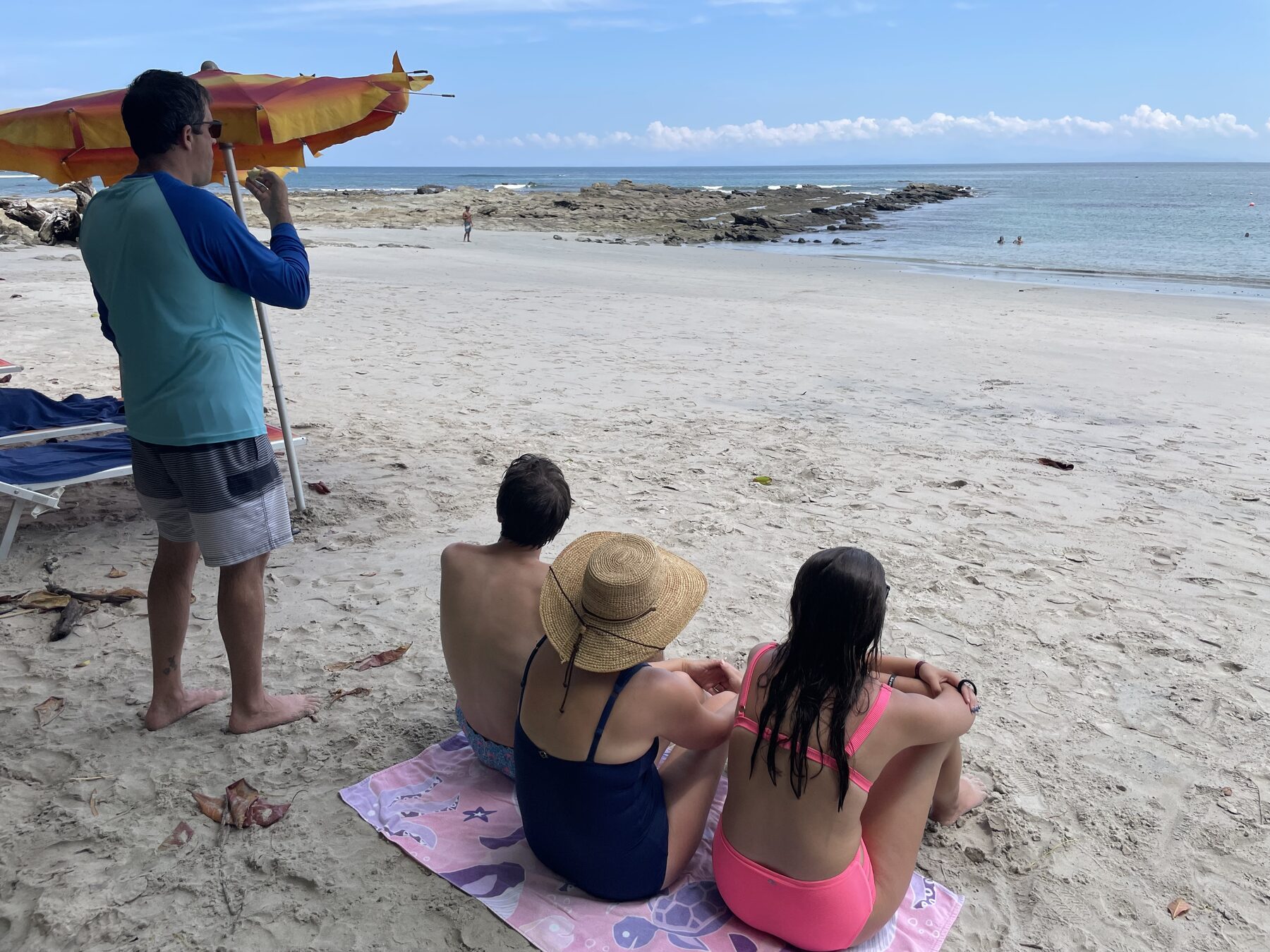 Real guests on the white sand at Playa Mantas after a Jaco beach snorkeling tour