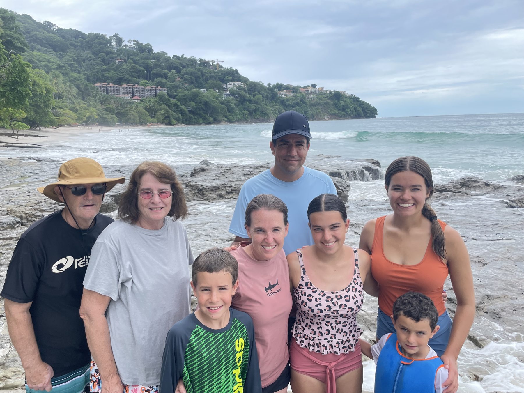 A family posing on the rocks at Playa Mantas after snorkeling — tours snorkeling Jaco beach