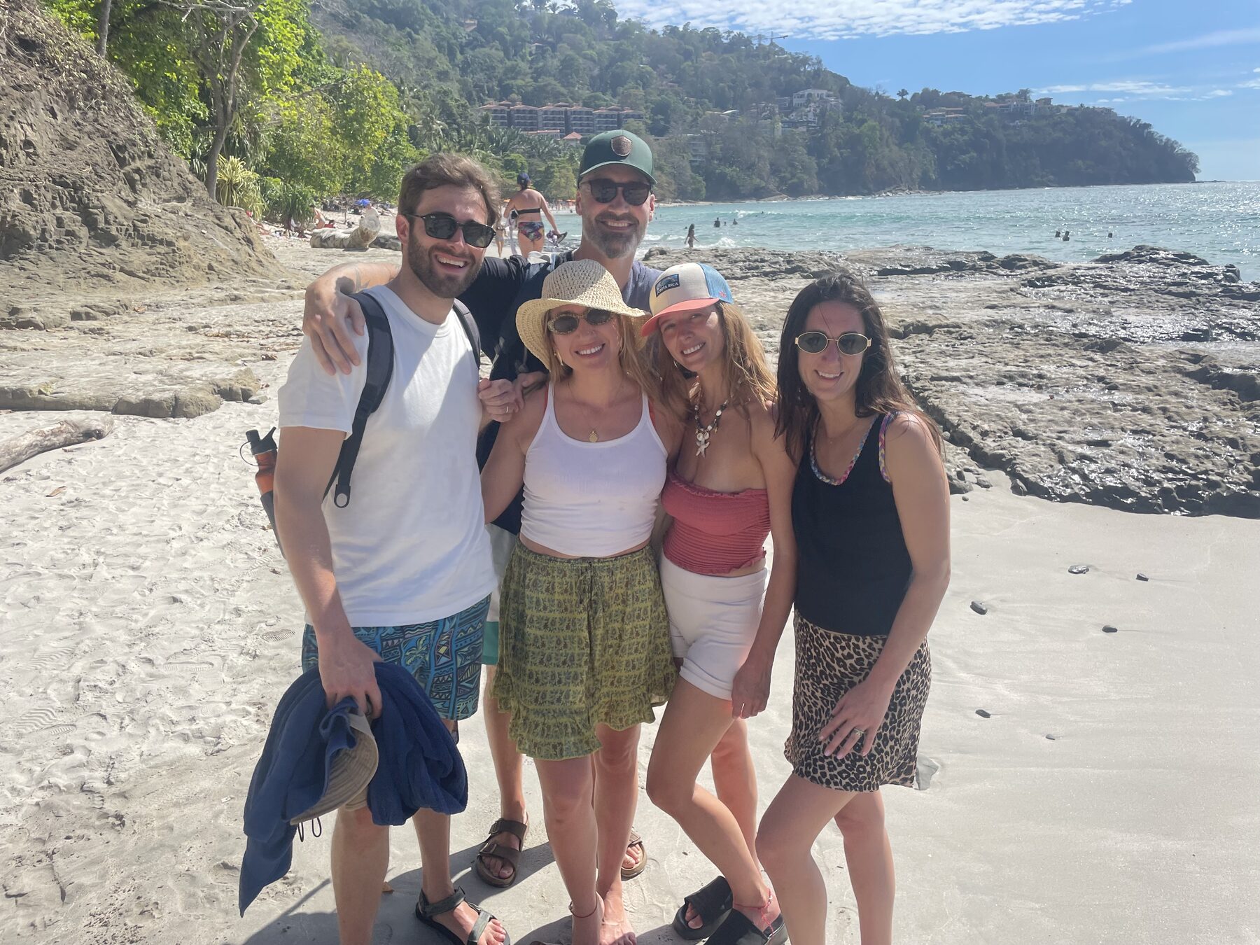 Group of friends at the secluded snorkel cove near Jacó Beach, Costa Rica