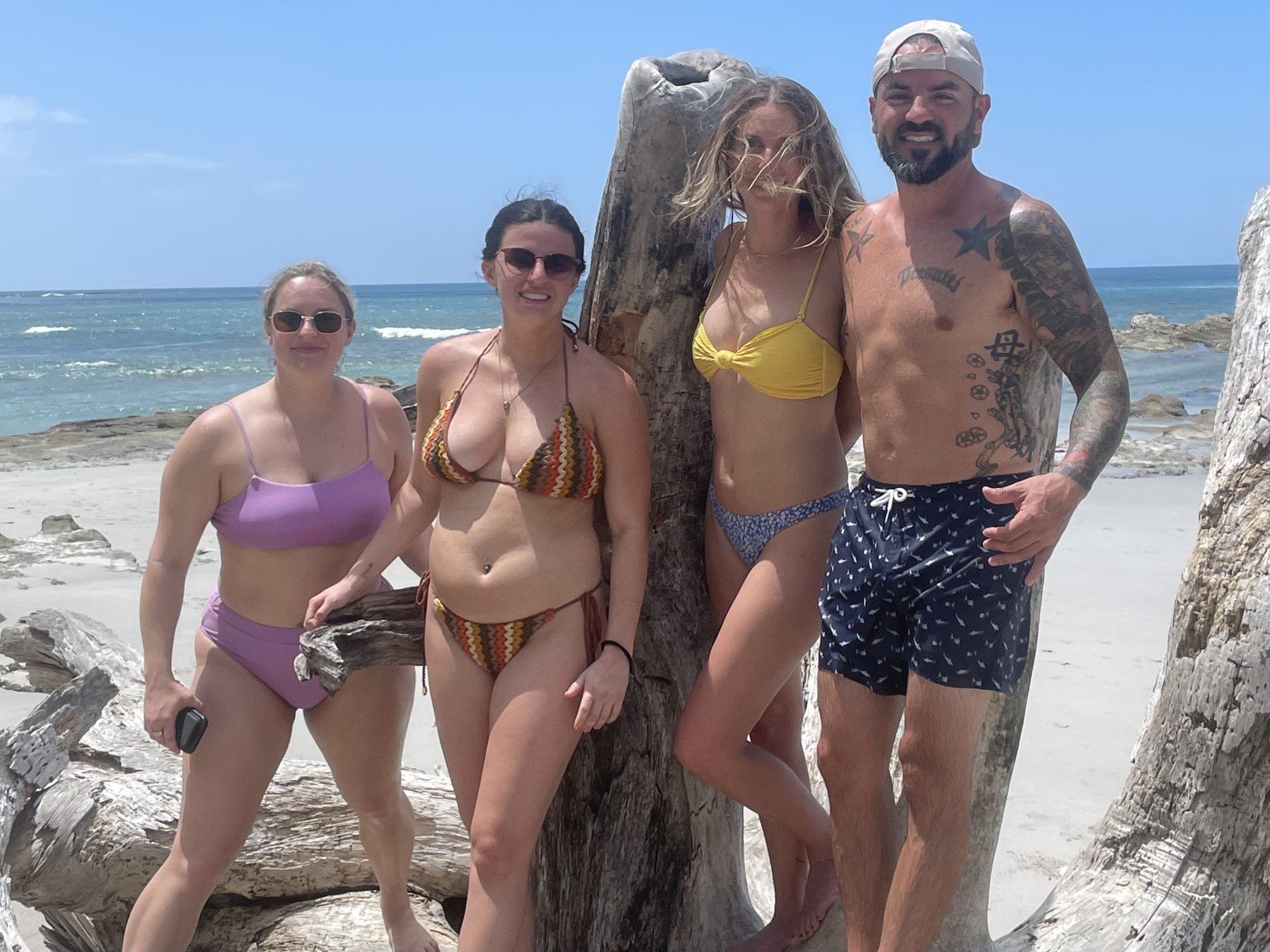 A group of friends on the beach at Playa Mantas on a best snorkel tour Jaco beach day