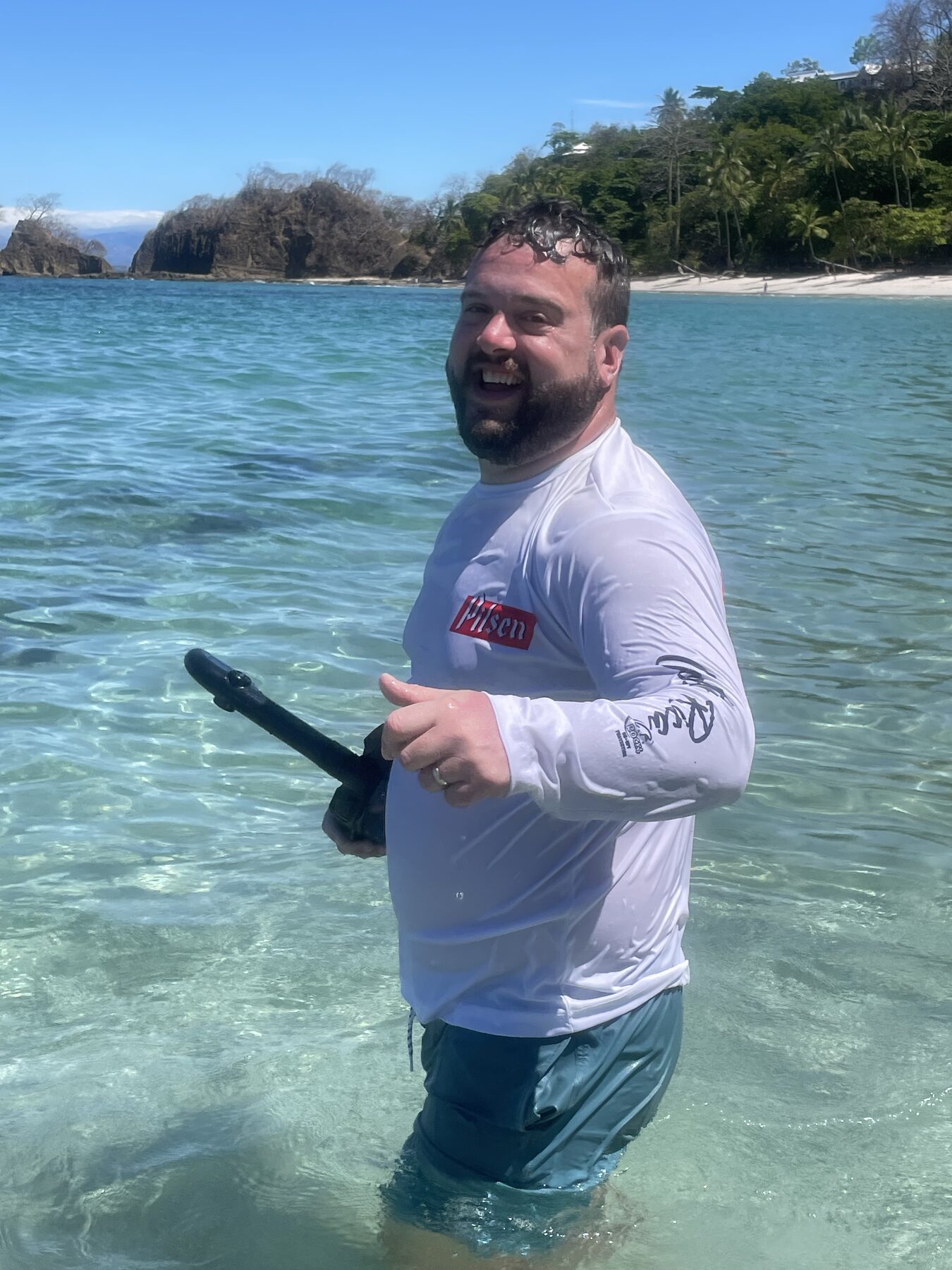 A snorkeler in the clear turquoise water of the cove near Jacó, Costa Rica