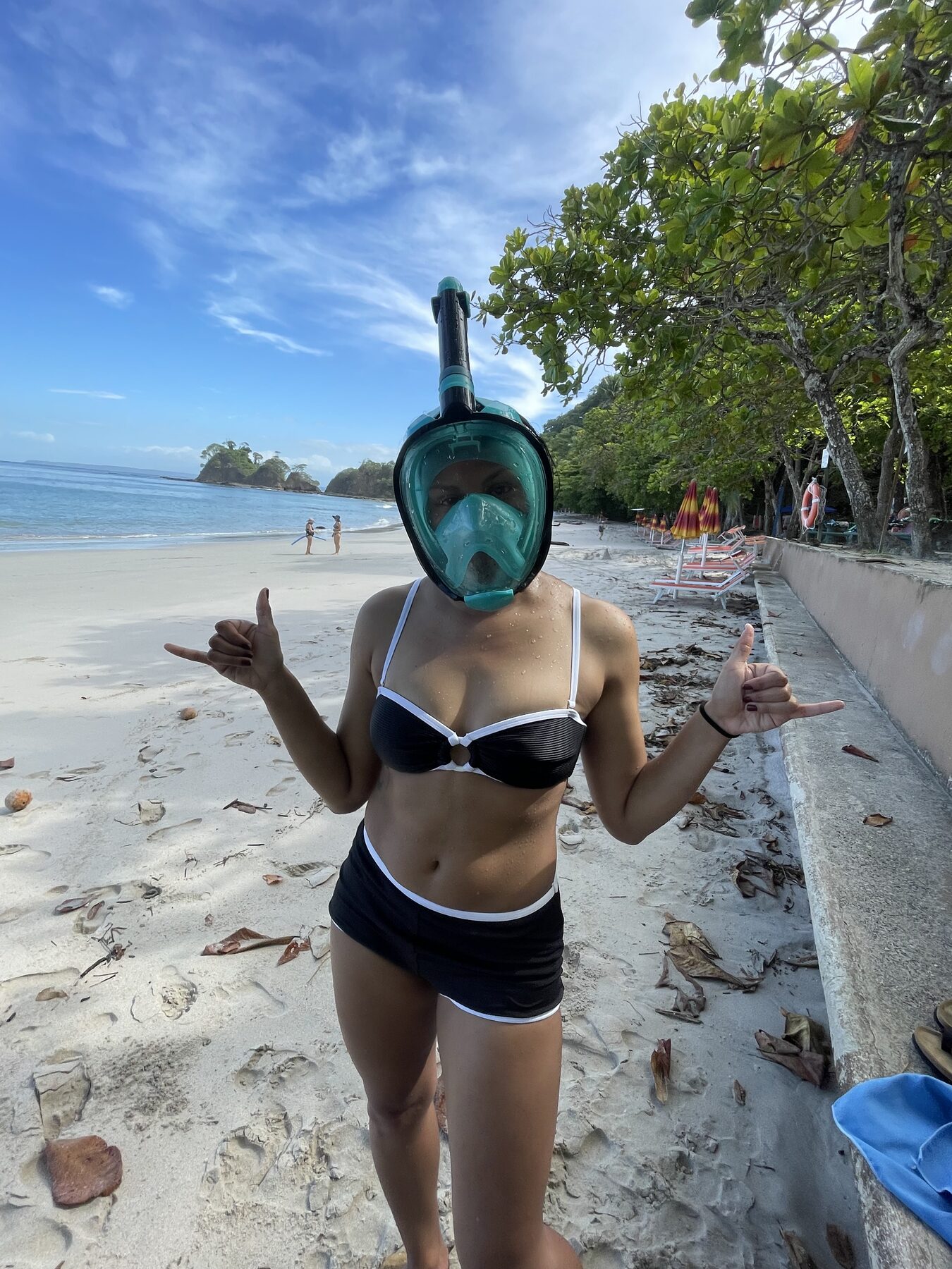 Guest in a full-face snorkel mask ready to snorkel at the clear cove near Jacó, Costa Rica