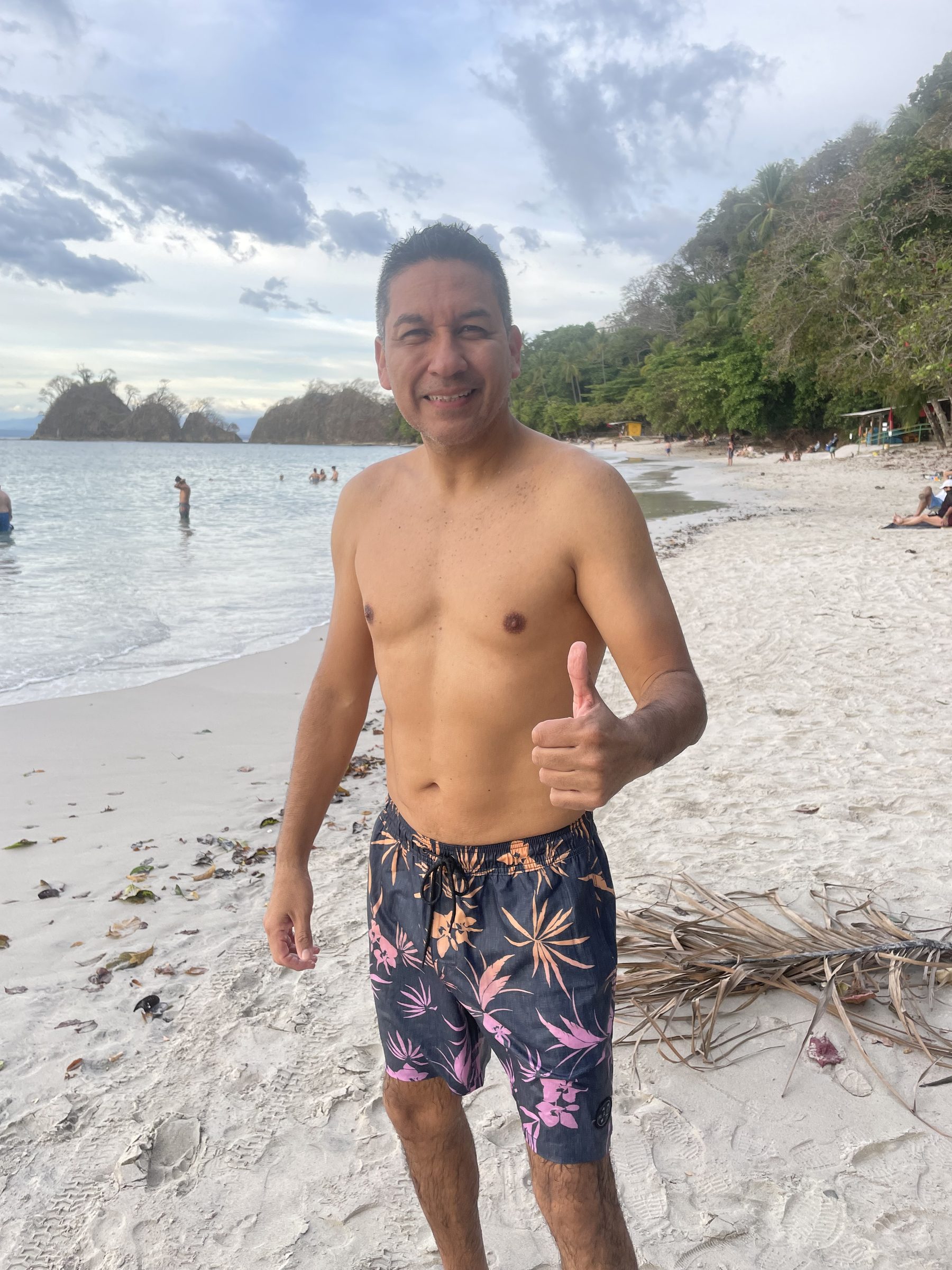 A happy guest on the white sand at Playa Mantas — top snorkel tour Jaco beach