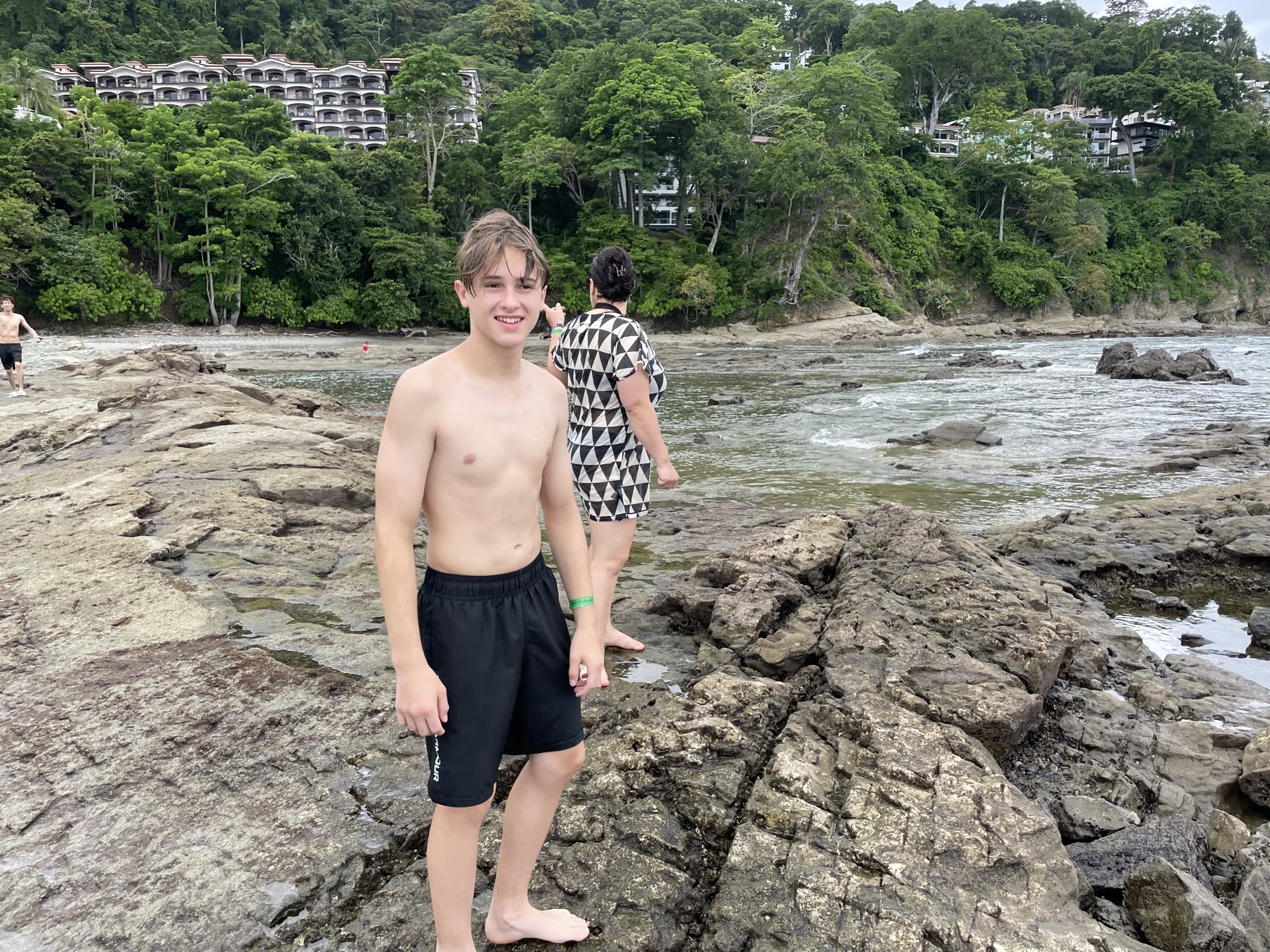 A young guest on the rocks at the cove at Playa Mantas — top snorkel tour Jaco beach