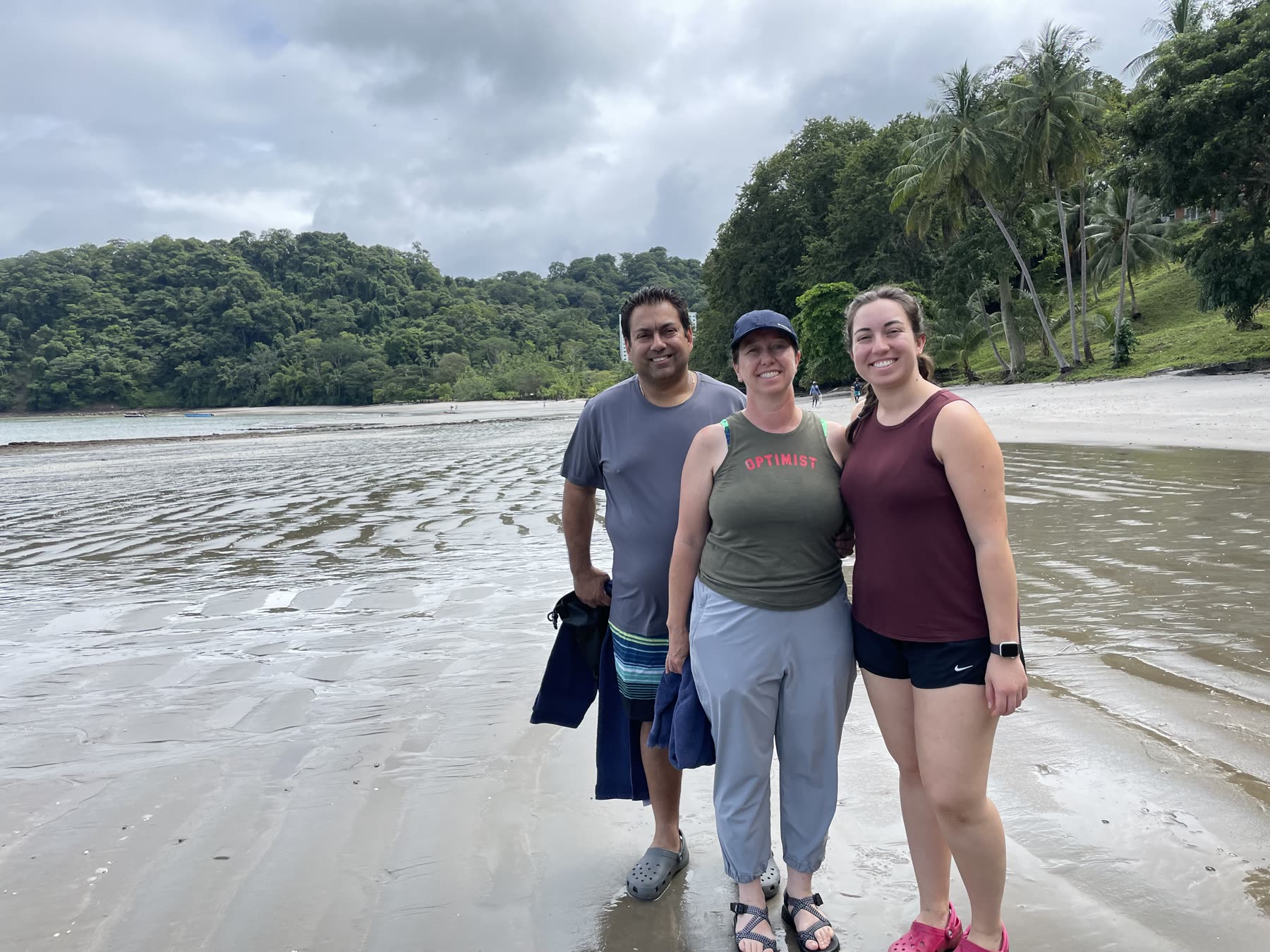 Three guests walking the sand at Playa Mantas — top snorkel tour Jaco beach