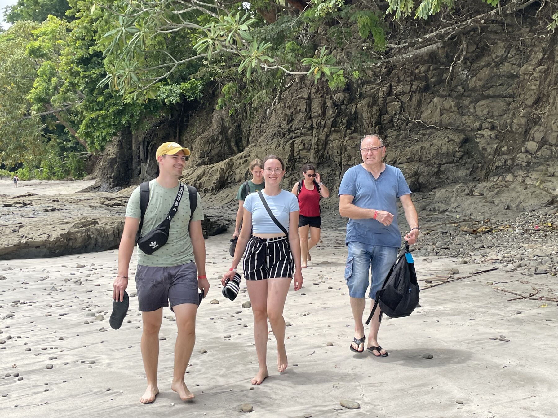 Three guests walking the sand at Playa Mantas — Jaco Costa Rica best snorkeling