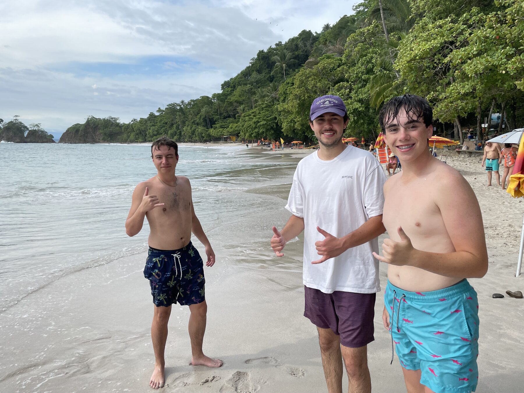Two friends throwing a shaka on the beach at Playa Mantas — top snorkel tour Jaco beach