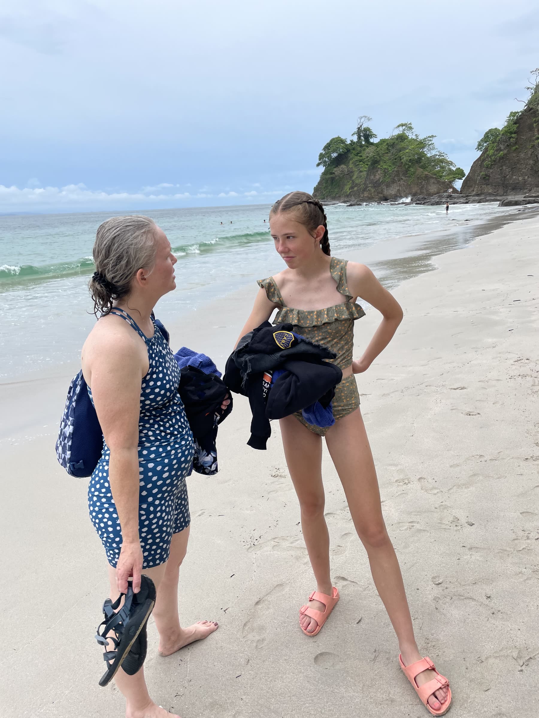 A mother and daughter with their gear at Playa Mantas on a best snorkel tour Jaco beach day