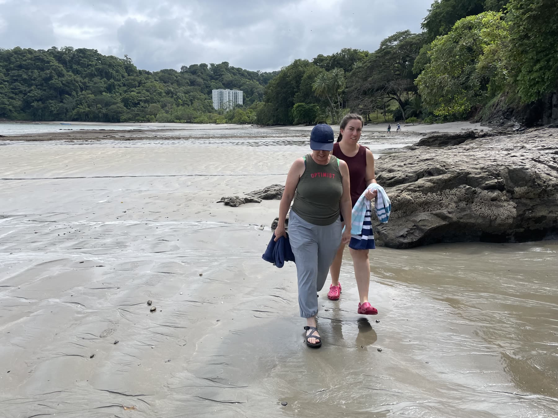 A mother and daughter walking the sand at Playa Mantas on a best snorkel tour Jaco beach day