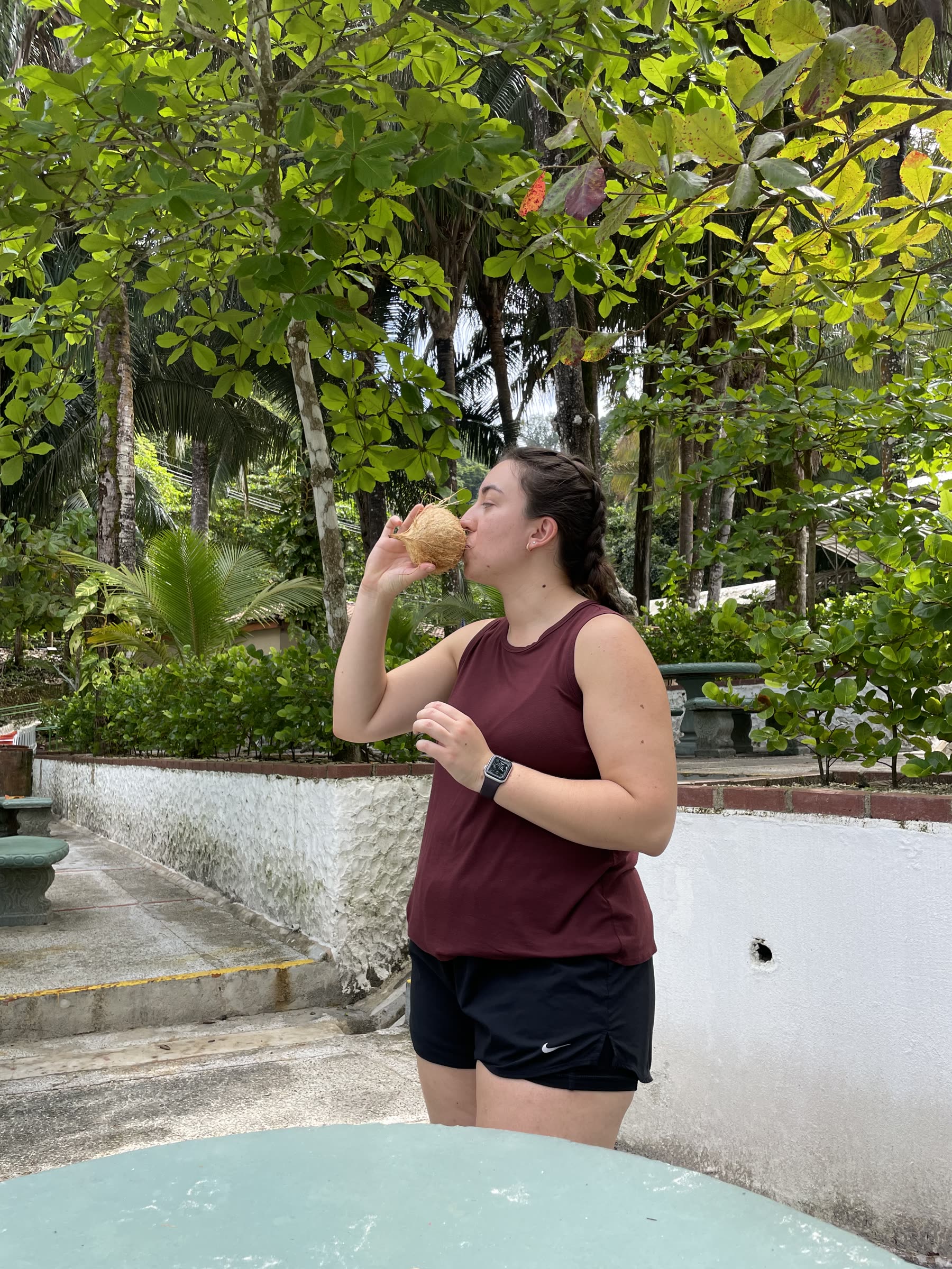 A guest with a fresh coconut at Playa Mantas — top snorkel tour Jaco beach